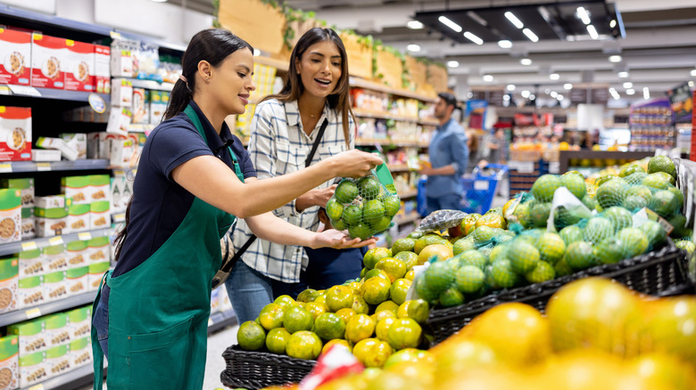 person getting help from grocery store employee