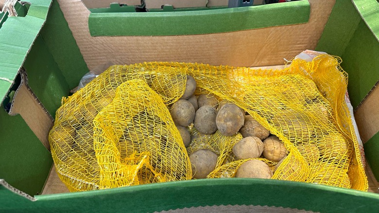 crate of unwashed potatoes