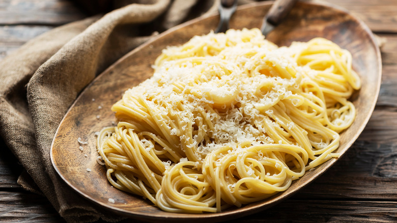 Bowl of spaghetti pasta topped with parmesan cheese