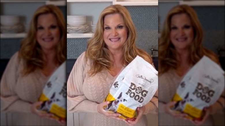 Trisha Yearwood holds bag of dog food