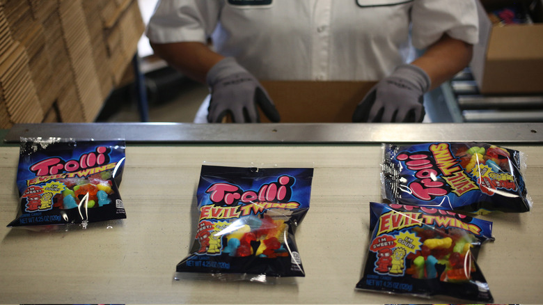 A worker boxes up Trolli products