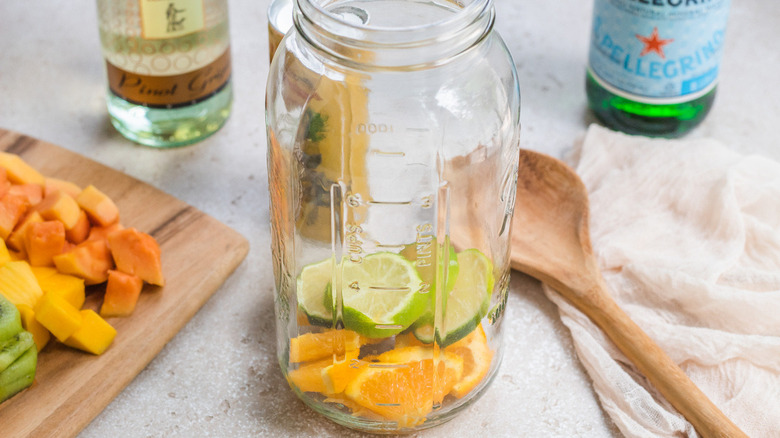 Glass jar partially filled with fruits