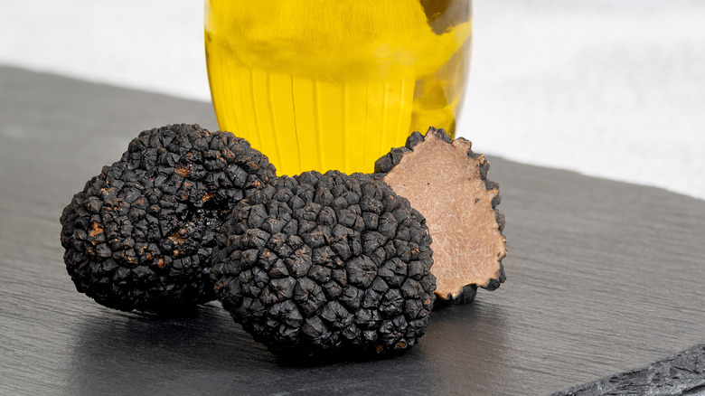 black truffles with bottle of oil