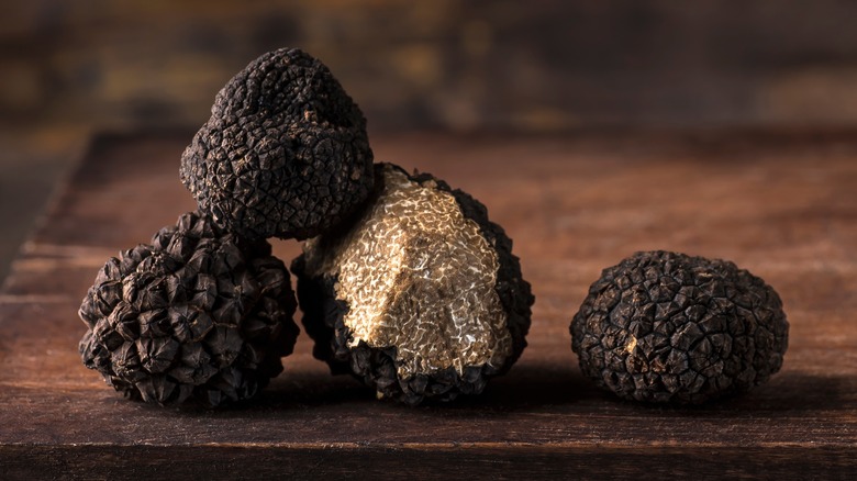 black truffles on wooden board