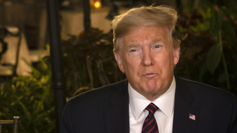 Donald Trump in front of a table of fast food