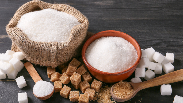 White and brown sugars in bowls and spoons