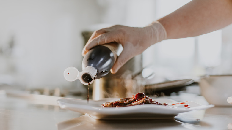 sauce being poured over dinner