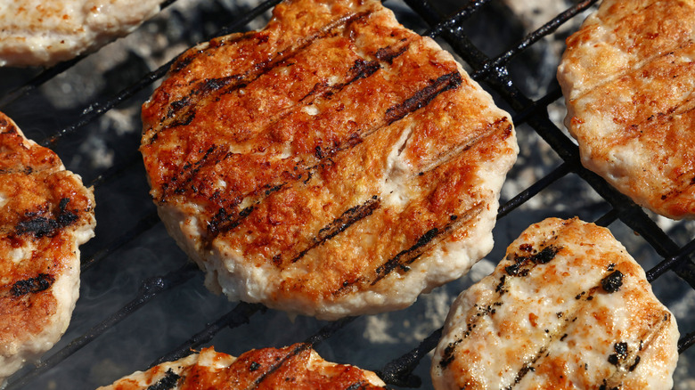 Turkey patties being cooked on a grill