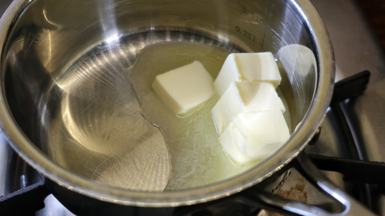 butter melting in metallic saucepan