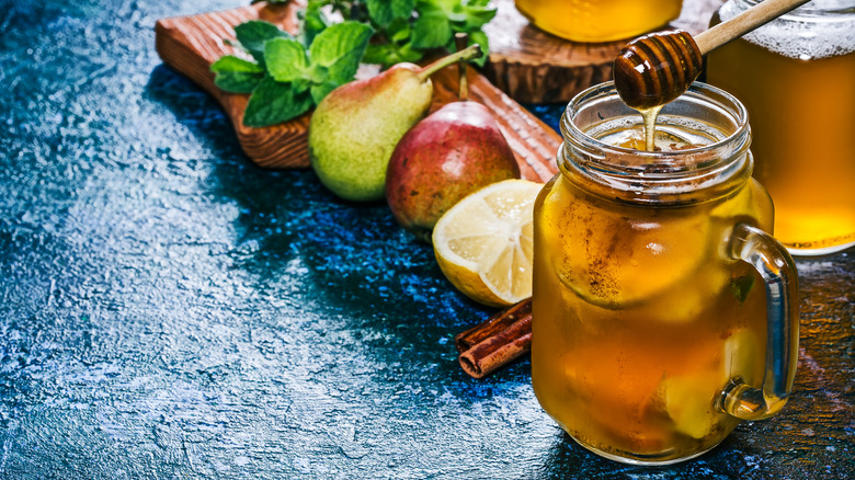 Glass of sangria with fruit and honey