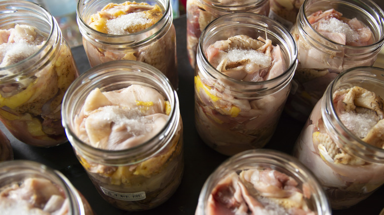 Raw meat in glass jars