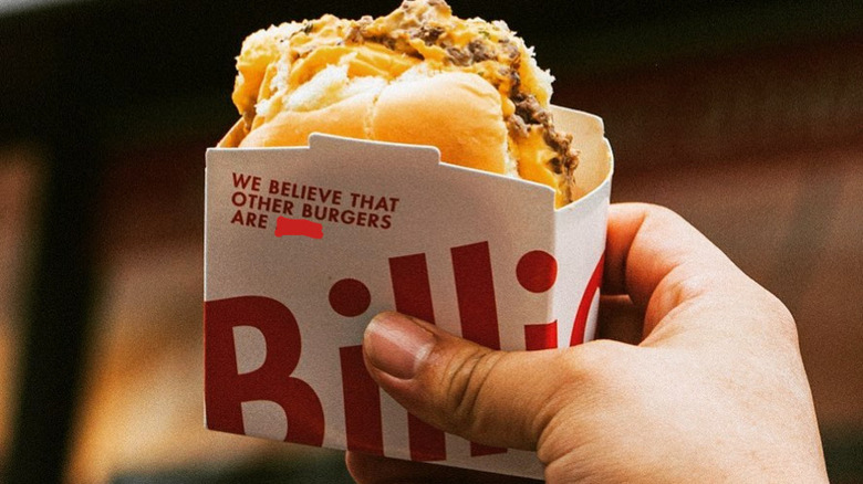 Hand holding Billionbox burger