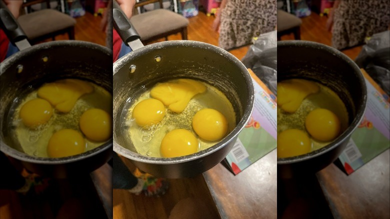 eggs cracked in pot