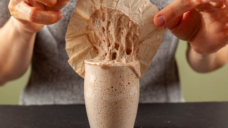 Overflowing sourdough starter.in jar 