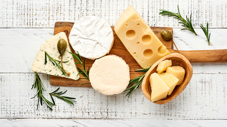 Various cheese on wooden board