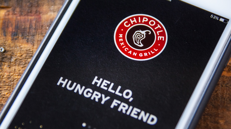 Phone screen with Chipotle logo reading Hello, Hungry Friend