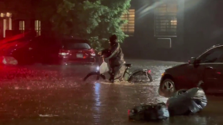 Cyclist with bag in flood