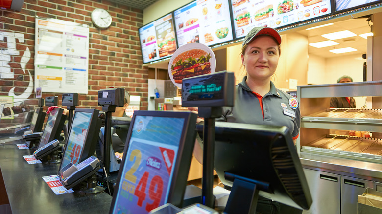 Woman working behind counter at Burger King