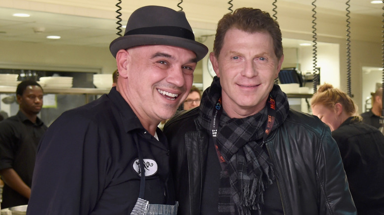 Michael Symon and Bobby Flay smiling 