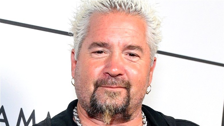 Guy Fieri with chin beard and hoop earrings