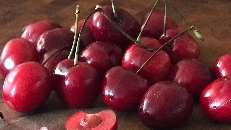 Coral champagne cherries against a brown background