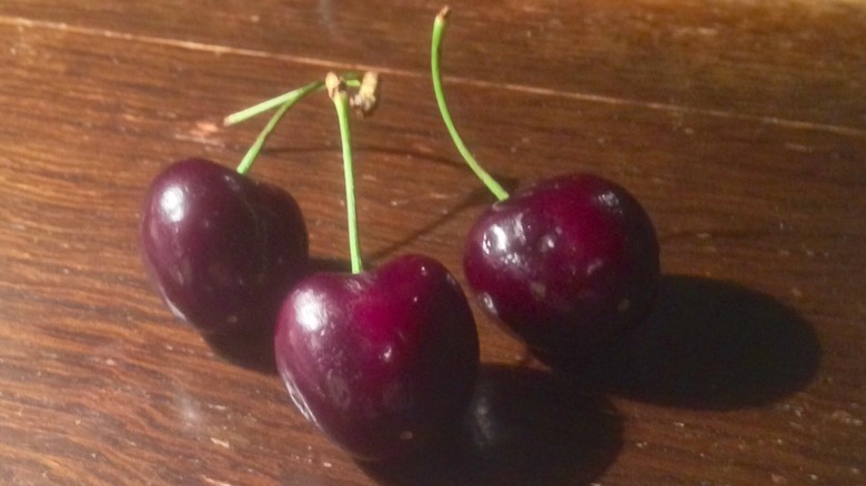 Santina cherries  against a wood table