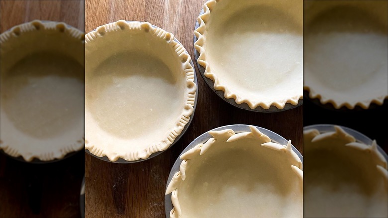 Crimped pie dough in pans