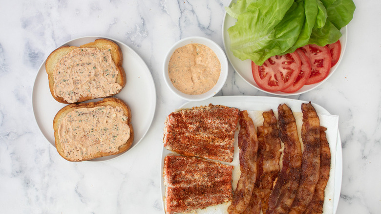 sandwich ingredients on white plates