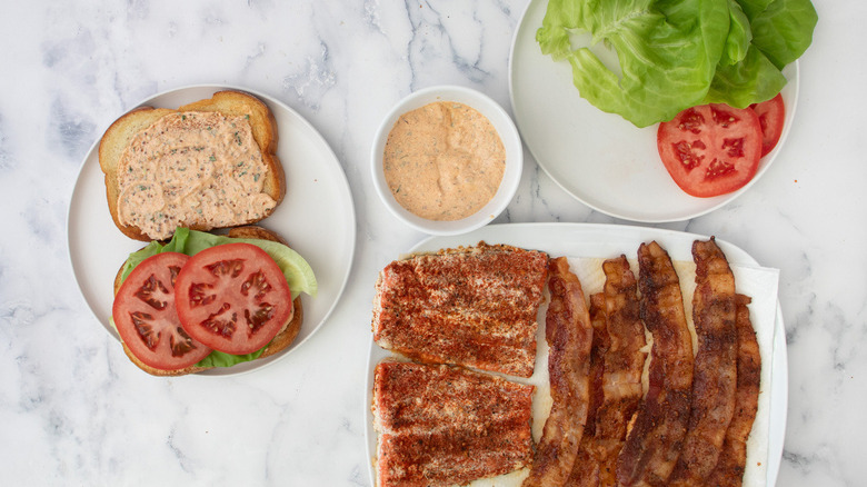 sandwich ingredients on white plates