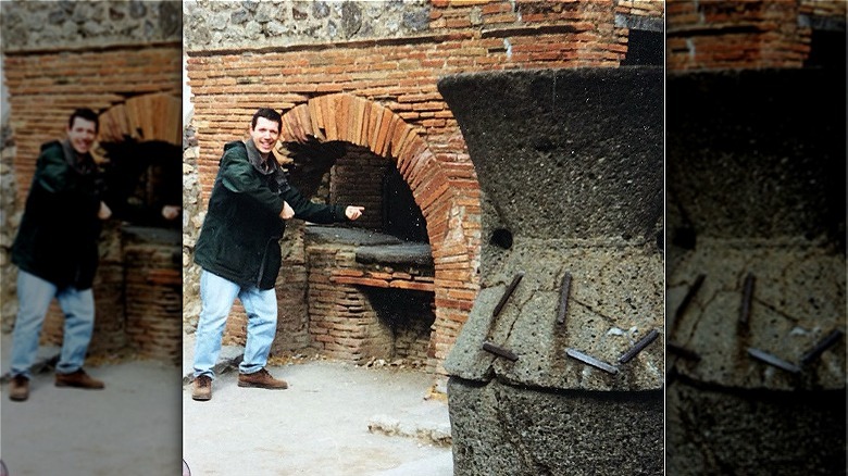 Person standing by brick oven