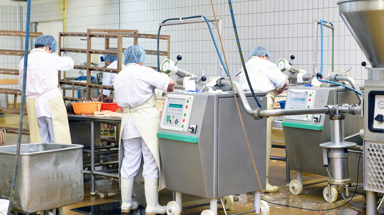 workers manufacturing sausages