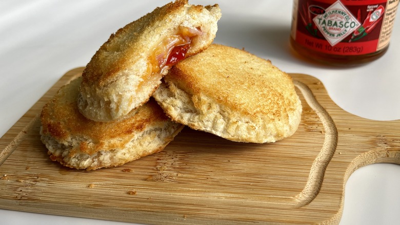 circular, jelly-filled sandwiches on a wooden board