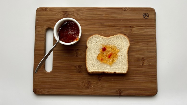 bread with jelly on a wooden board