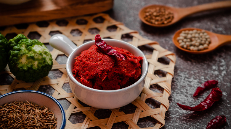 a bowl of Thai chili paste on a table with other dishes