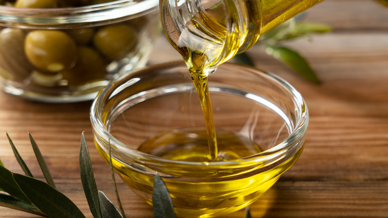 pouring olive oil into bowl