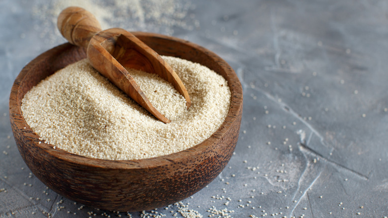 Fonio grain in wooden bowl with scoop