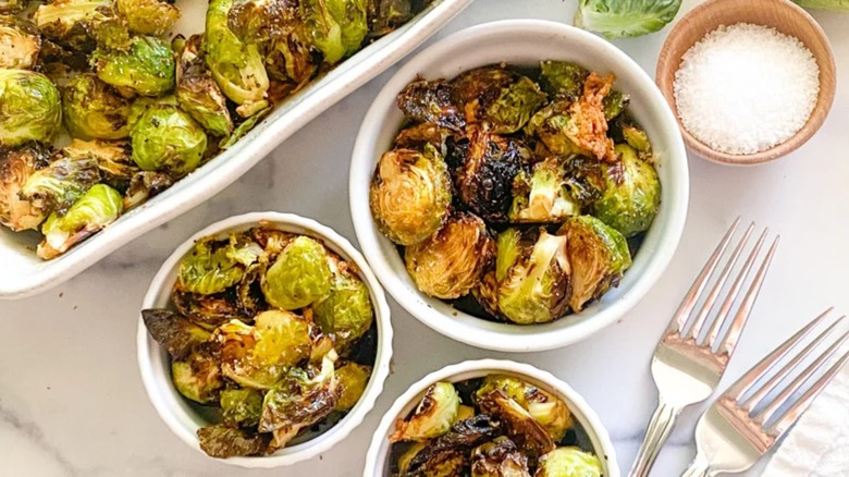 Brussels sprouts in white bowls