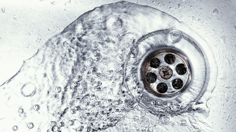 Clean water swirling down a sink's drain