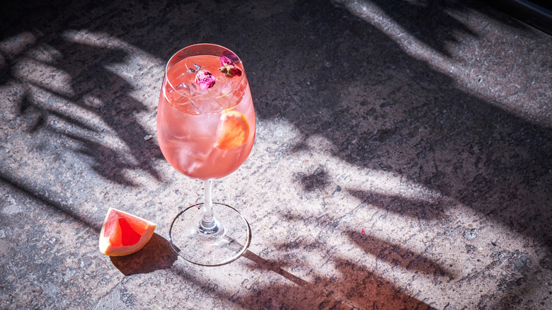 Flower-garnished spritz in sunlight 