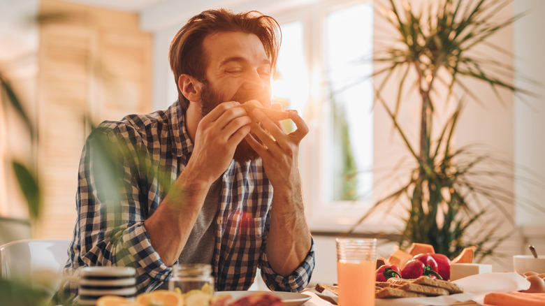 man eating breakfast at table