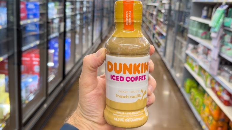 shopper holding Dunkin iced coffee