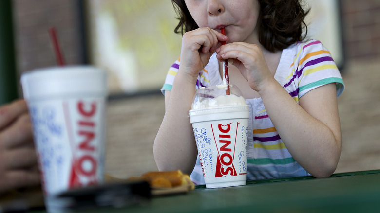 Girl drinking Sonic milkshake 