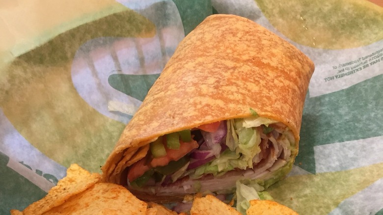 Subway wrap on a wrapper with chips 