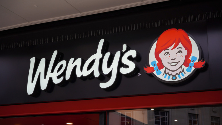 The Wendy's store sign features the chain's logo with a red-headed girl.