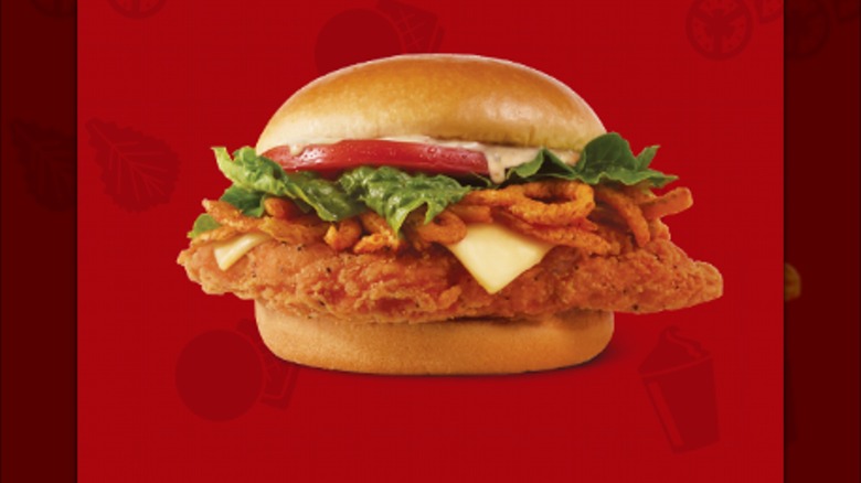 The Ghost Pepper Ranch sandwich is on a red background.