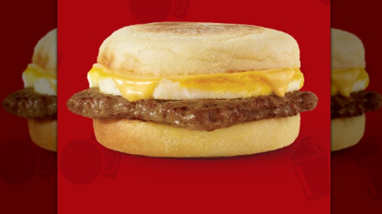 This English muffin from Wendy's has sausage and cheese on it.