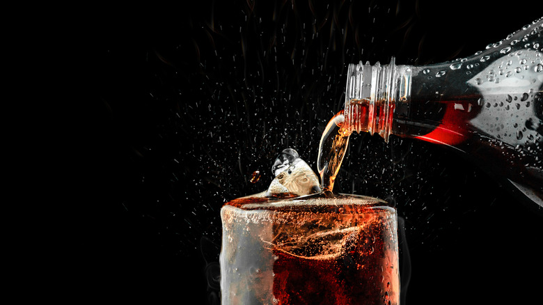 pouring soda into glass