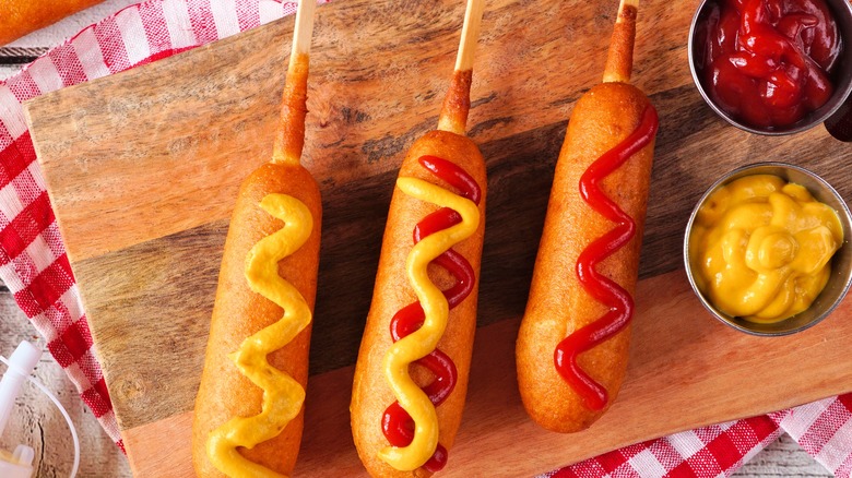 Corn dogs with condiments