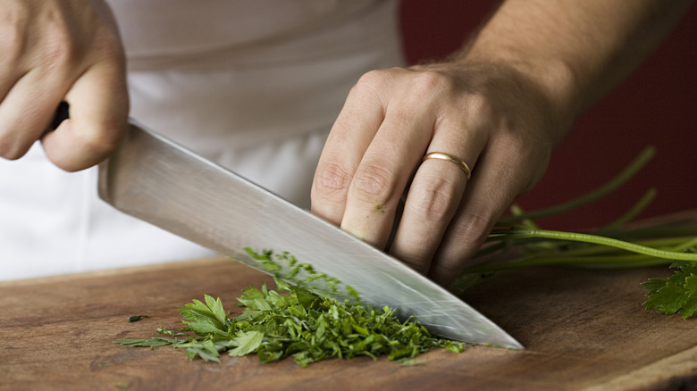 Person chopping cilantro