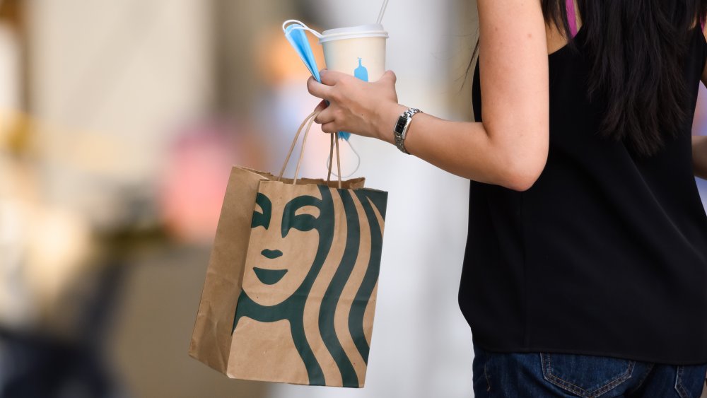 woman carrying a Starbucks bag